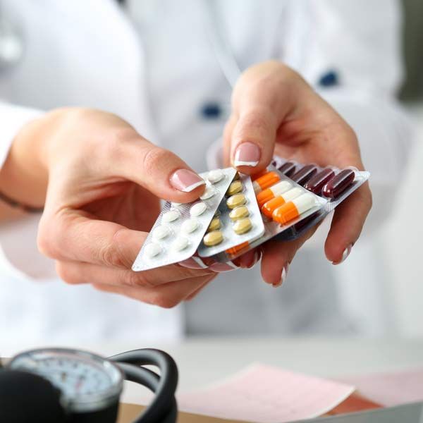 Doctor handing out pills Representing Natural Remedies for Polycystic Ovary Syndrome