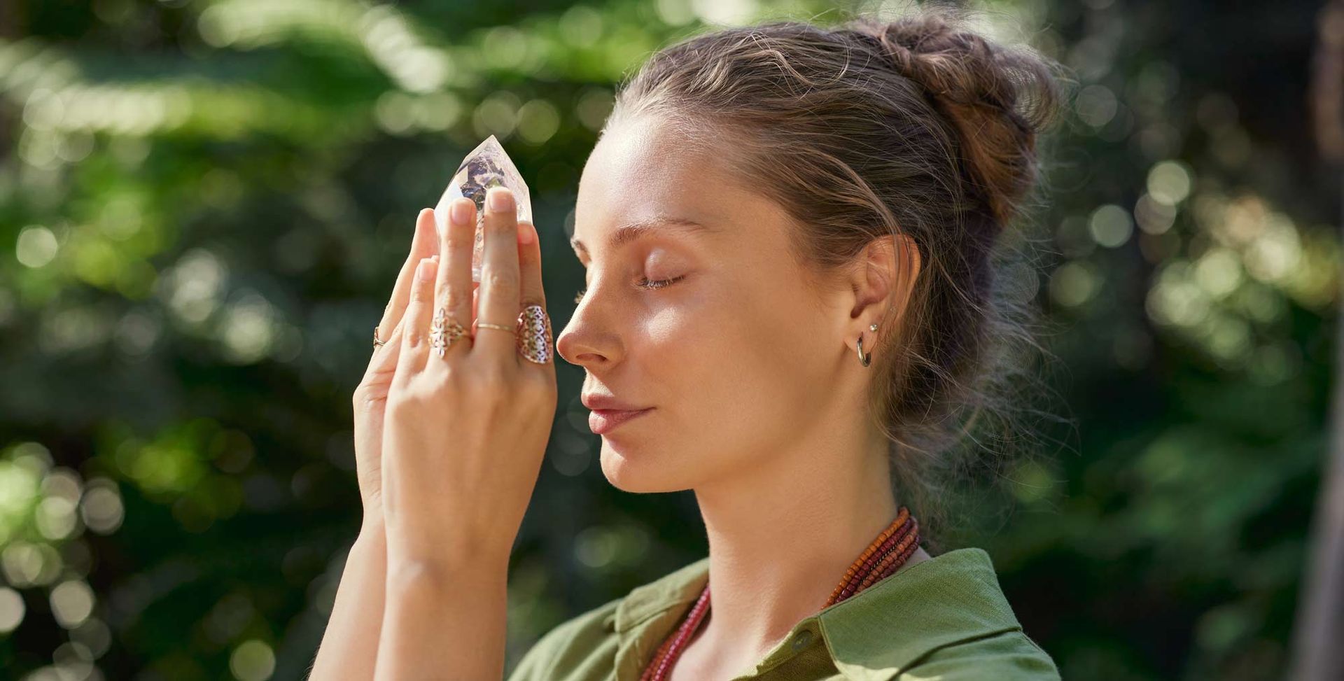 A woman is holding a crystal in front of her face Understanding the Mind-Body Connection
