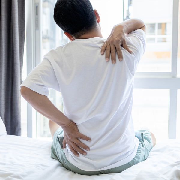 A man with chronic muscle pain in his back