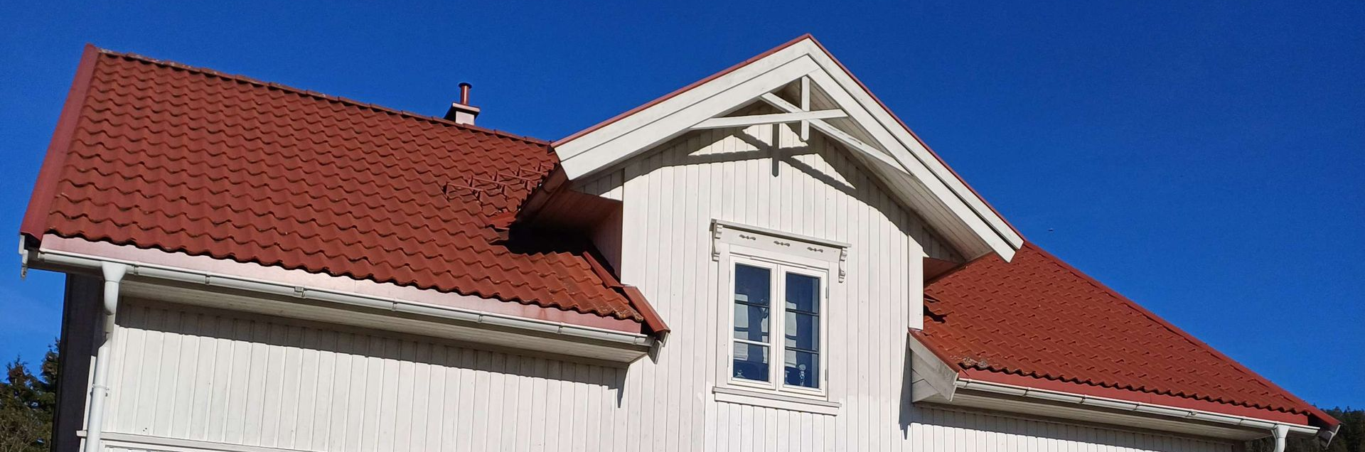 Mossy tiled roof with windows above.