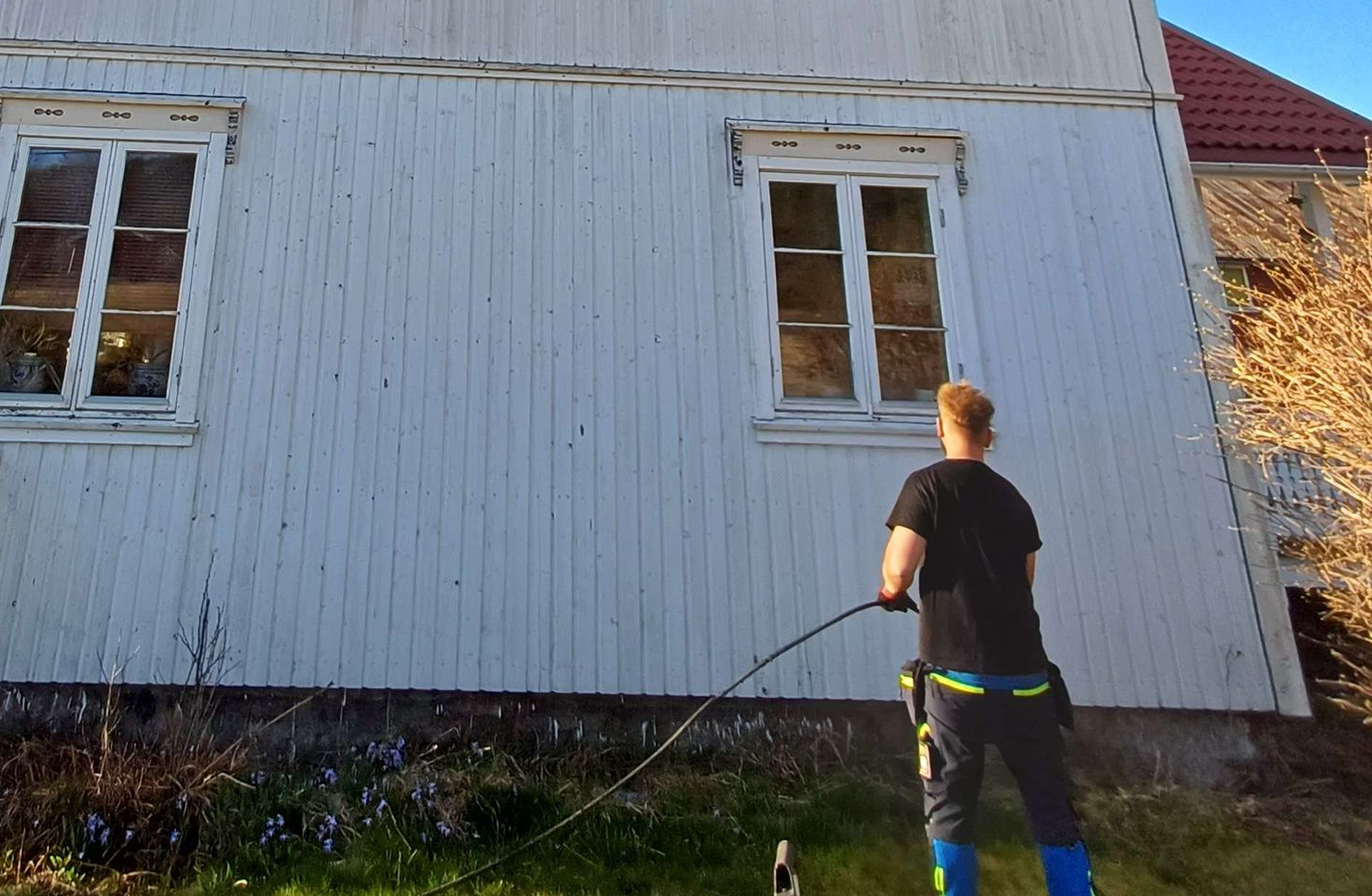 Close-up of a red tile roof with a metal rail running along the top.
