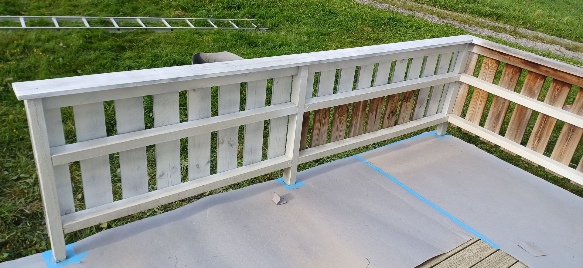 Brown tiled roof, top-down view; residential area with green foliage and asphalt road in the background.