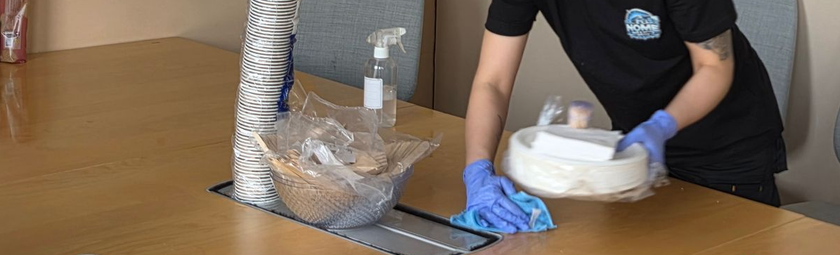 Damaged roof tiles, with sections missing, over a patch of brown vegetation.
