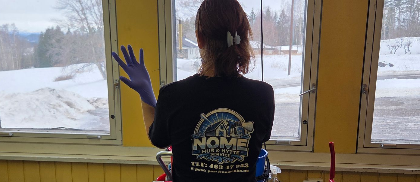 Damaged wooden structure with missing boards, revealing interior. Dark, weathered appearance.