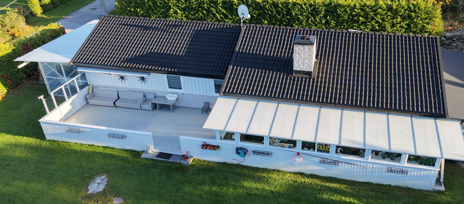 Mossy tiled roof with windows above.
