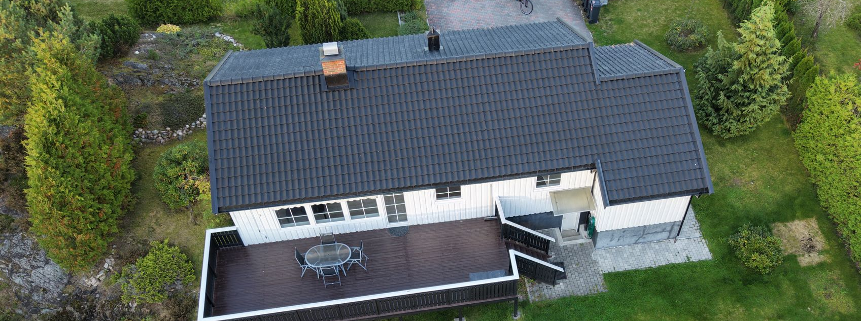 Mossy tiled roof with windows above.