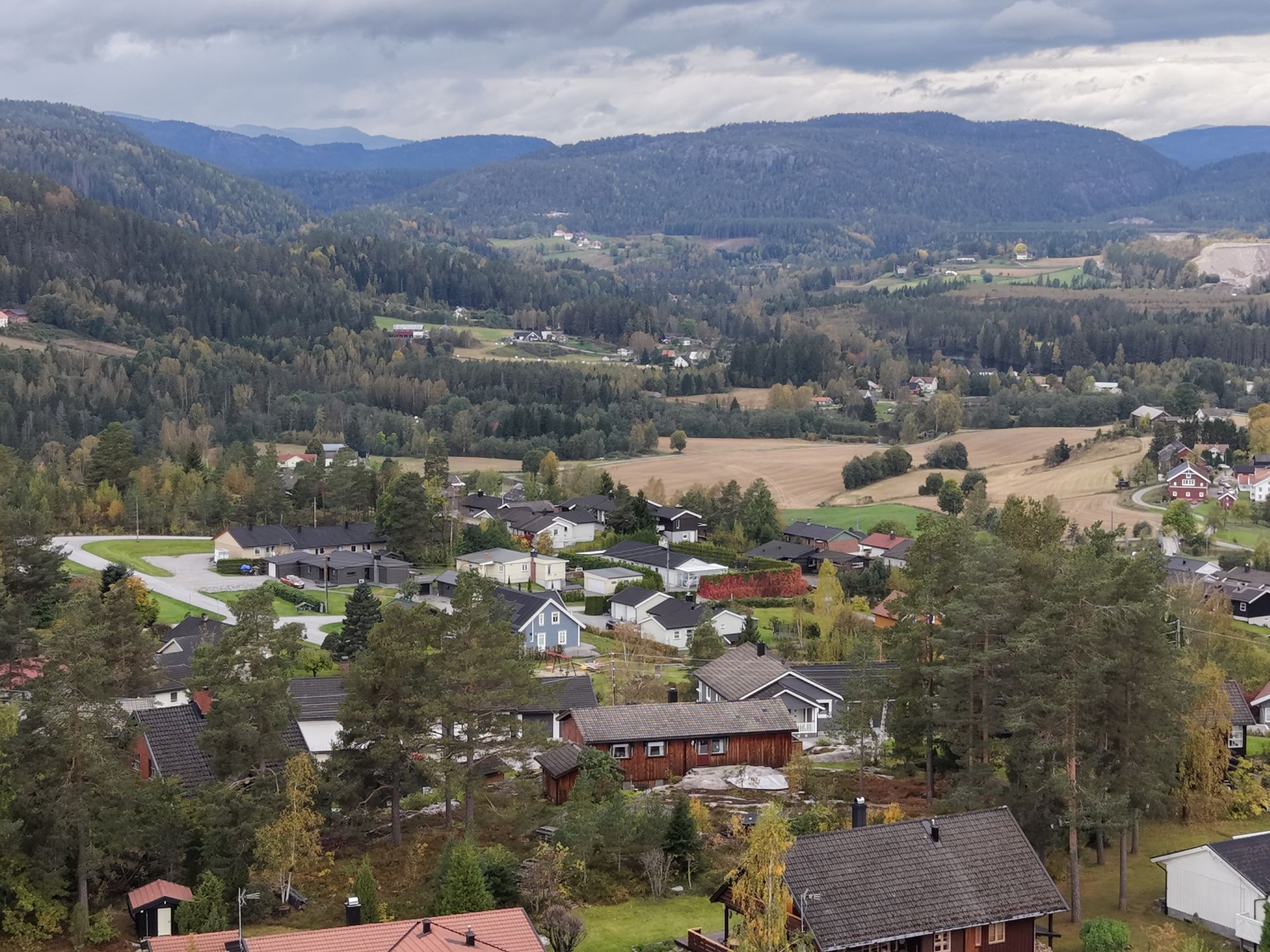 Close-up of a red tile roof with a metal rail running along the top.