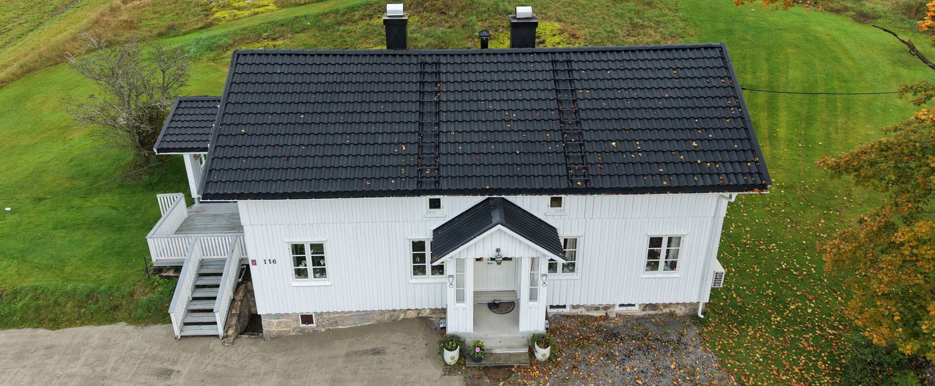 Close-up of a red tile roof with a metal rail running along the top.