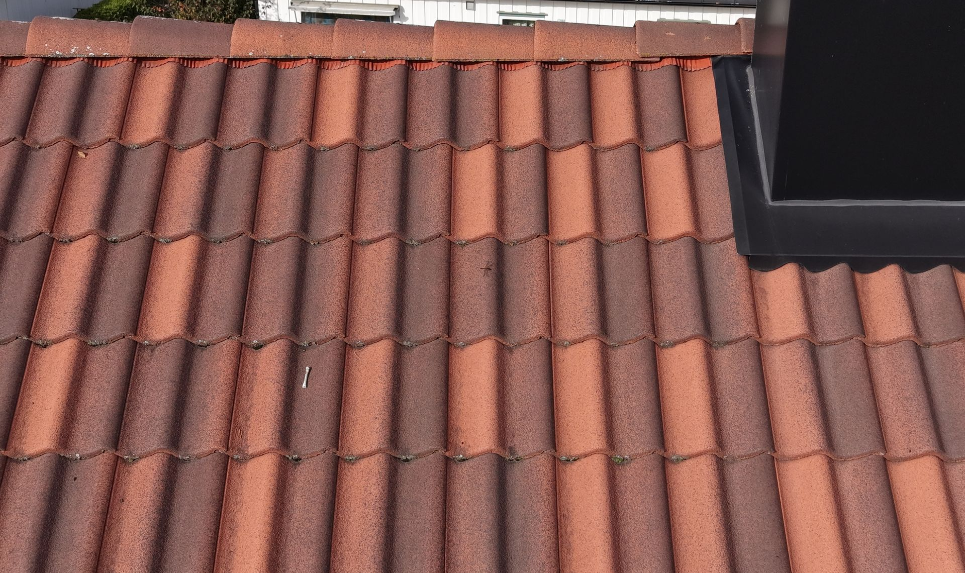 A wall clock featuring a blue and white logo for 