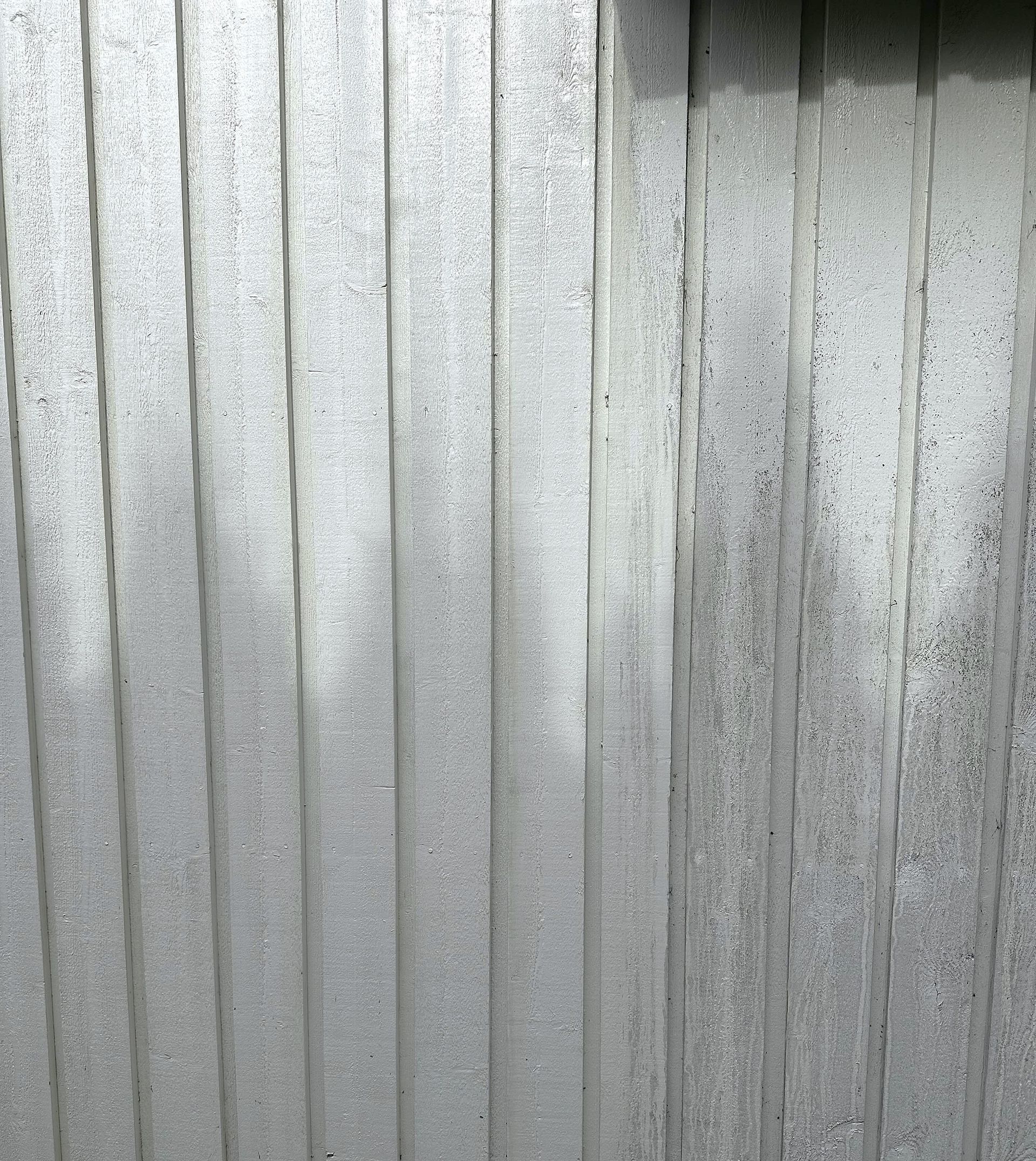 Brown tiled roof, top-down view; residential area with green foliage and asphalt road in the background.