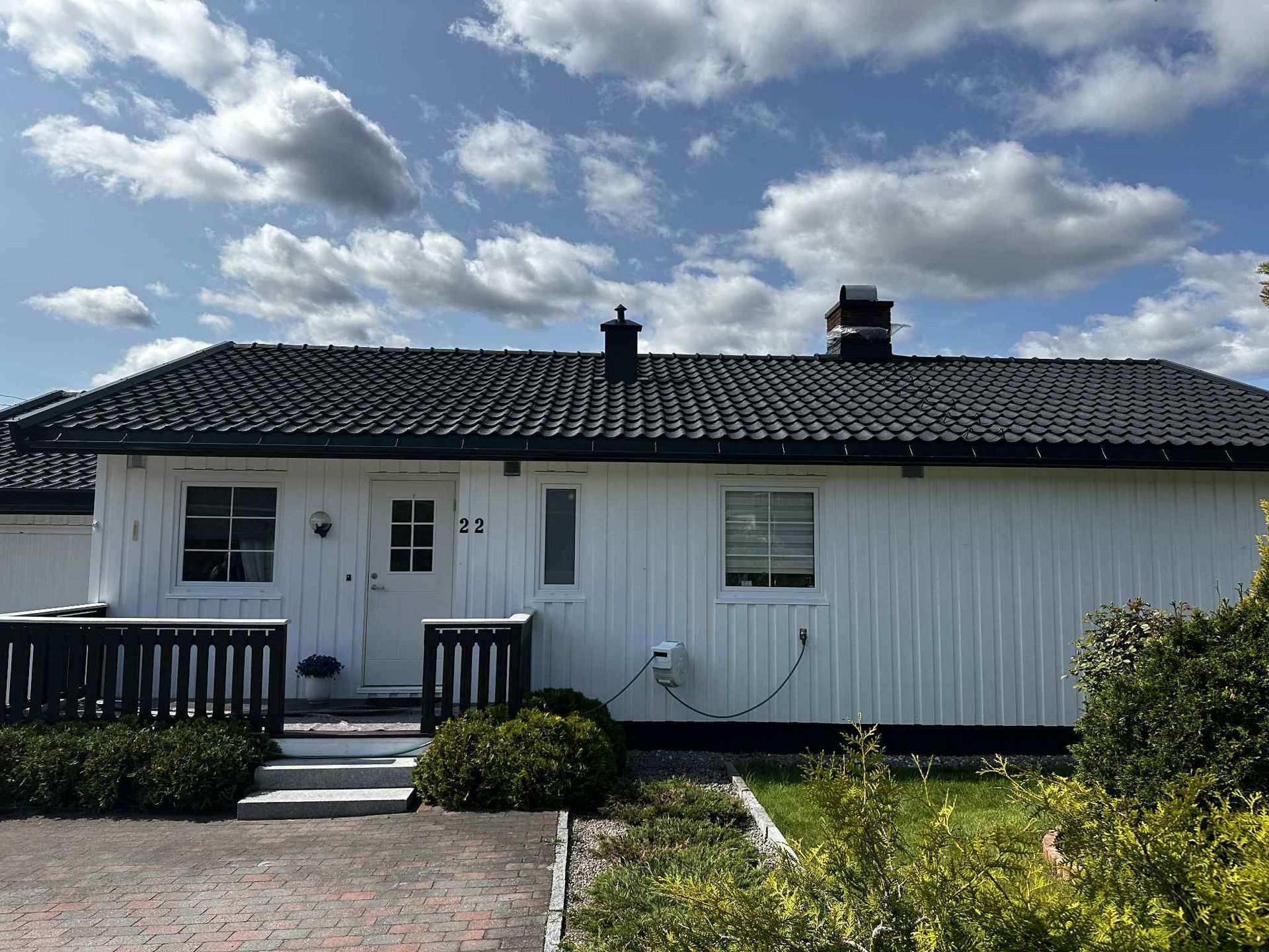 Shadows of two people on green grass.