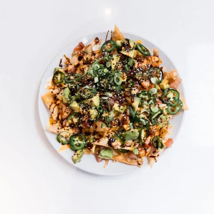 nachos topped with avocado slices