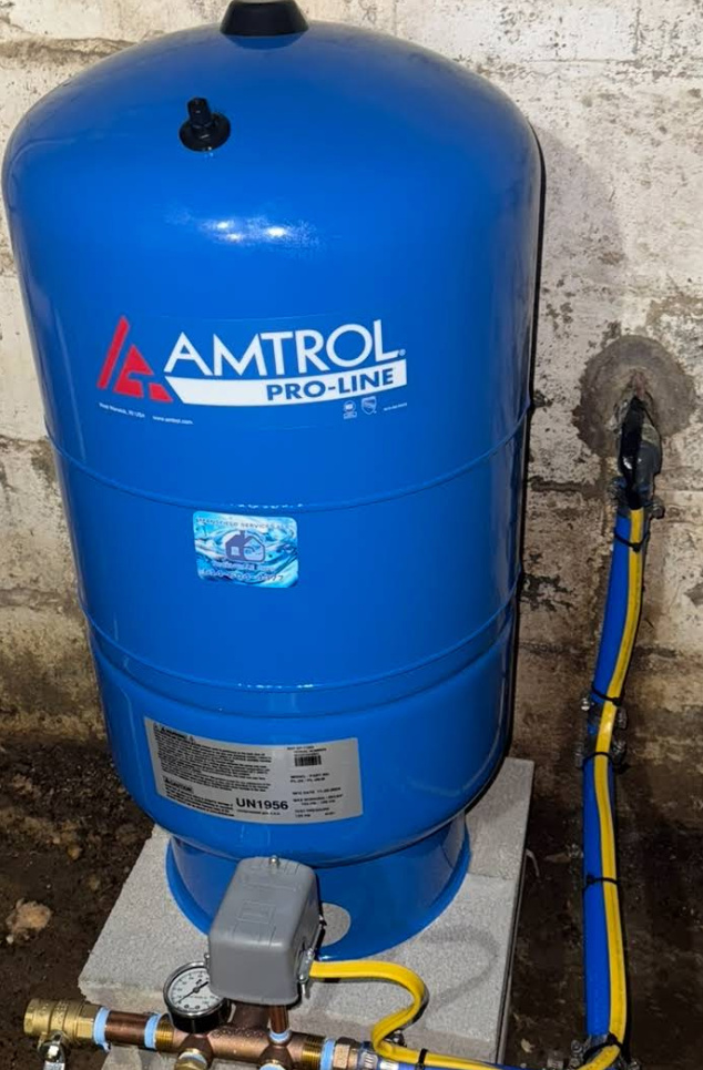 Three tanks are lined up next to each other in front of a blue tank.