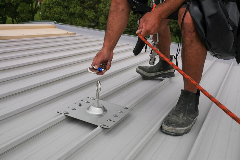 A Man Is Working on A Metal Roof — Site Safety NSW in Central Coast, NSW
