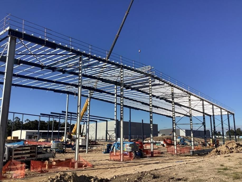 A Large Metal Structure Is Being Built with A Crane — Site Safety NSW in Port Stephens, NSW