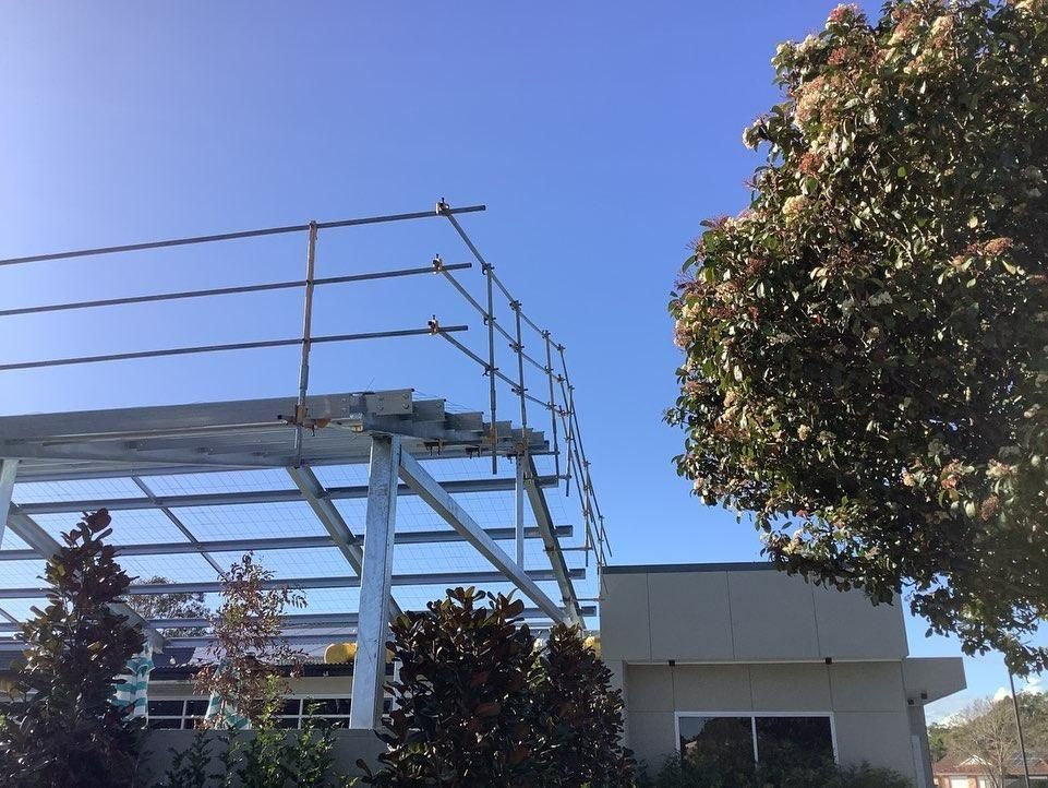 A Building Under Construction with A Tree in The Foreground — Site Safety NSW in Central Coast, NSW