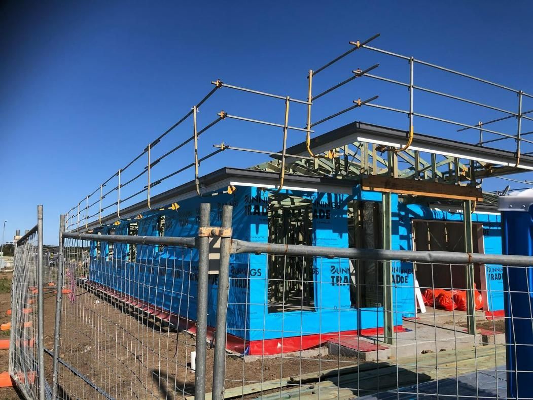 A Building Under Construction Is Behind a Fence — Site Safety NSW in Lake Macquarie, NSW