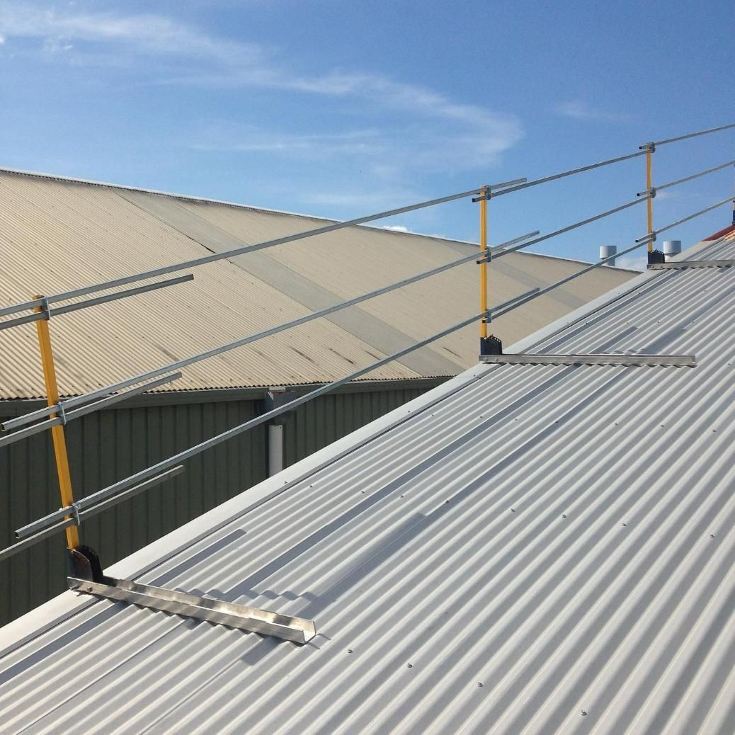 A Metal Roof with A Yellow Railing Attached to It — Site Safety NSW in Mid North Coast, NSW
