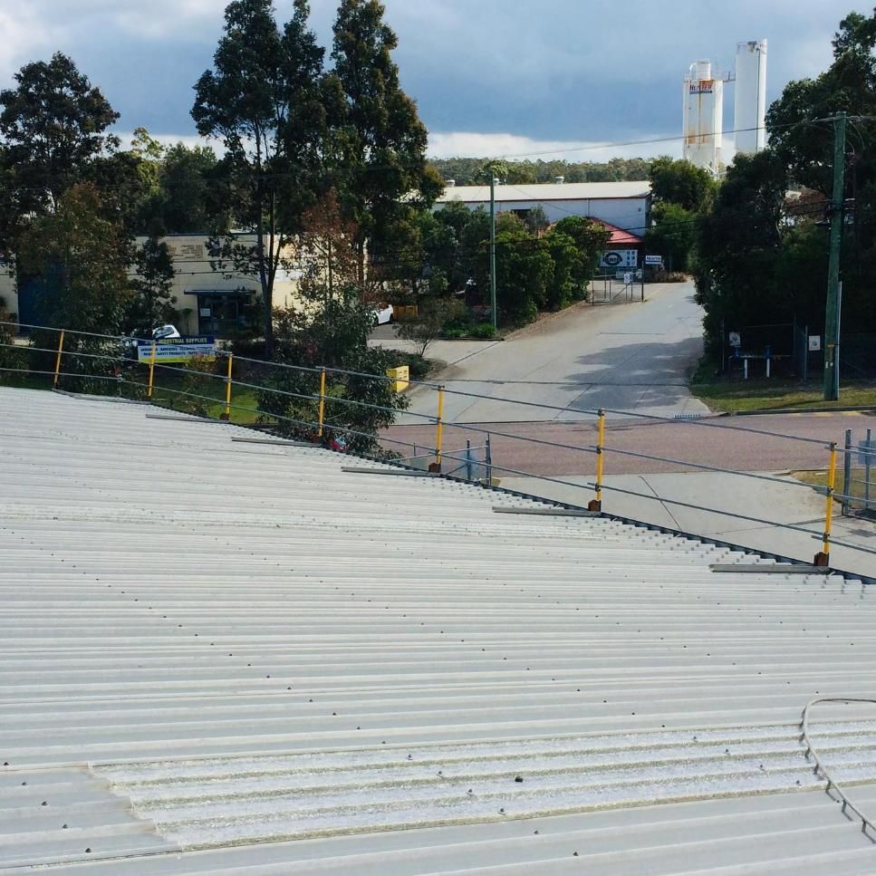 The Roof of A Building with A Fence Around It — Site Safety NSW in Port Macquarie, NSW