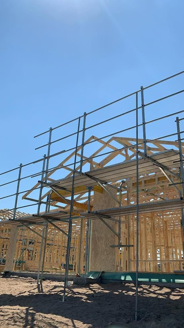 A Building Under Construction with Scaffolding and A Blue Sky in The Background — Site Safety NSW in Maitland, NSW