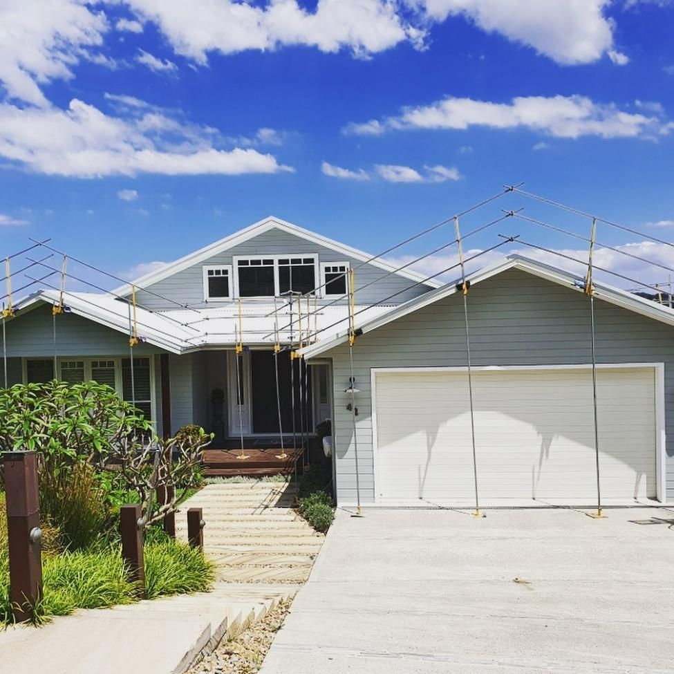 A House with A White Garage Door Is Under Construction — Site Safety NSW in Maitland, NSW