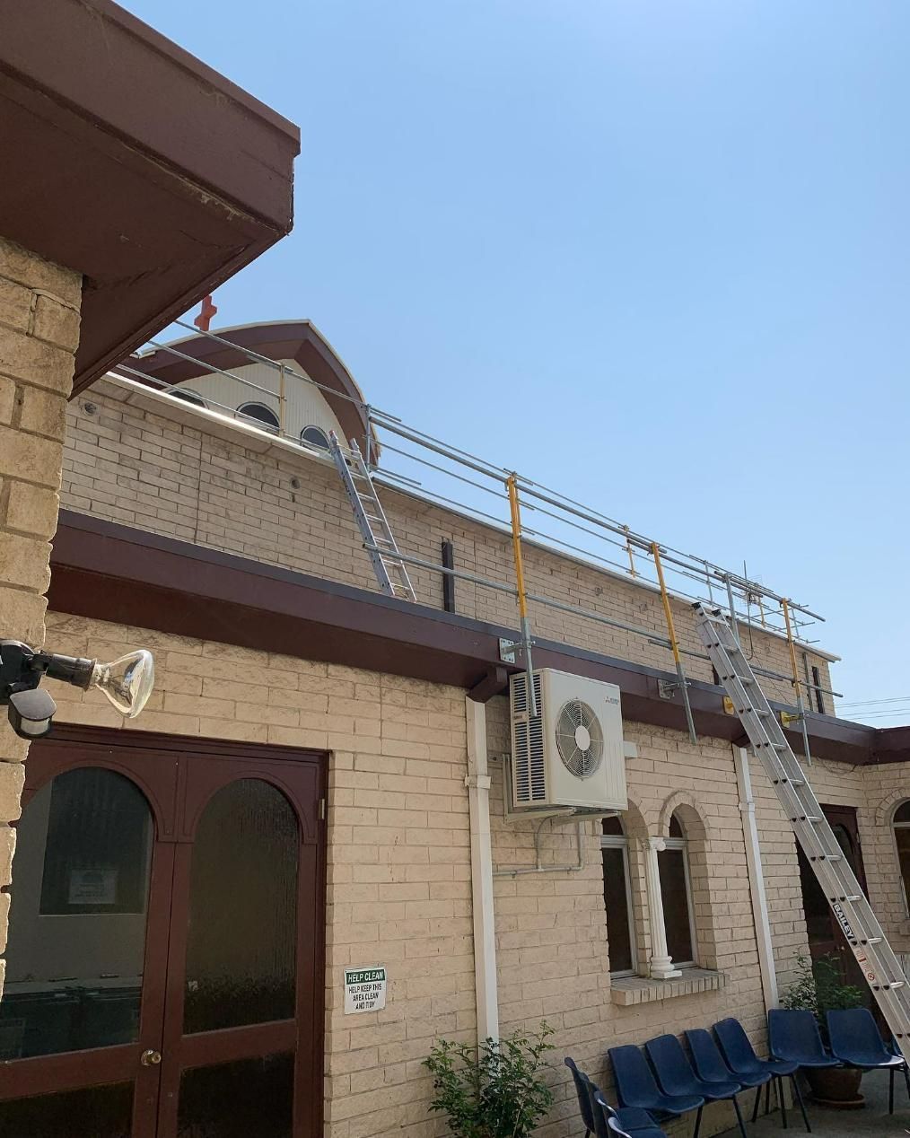 There Is a Ladder on The Roof of A Building — Site Safety NSW in port Stephens, NSW