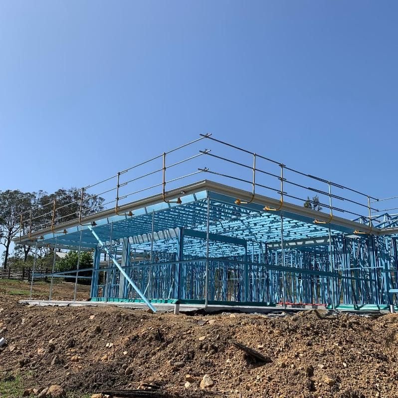 A Building Under Construction Is Sitting on Top of A Dirt Hill — Site Safety NSW in Port Macquarie, NSW