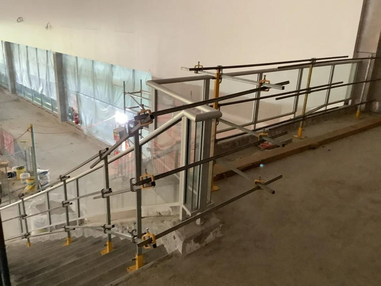A Staircase with A Metal Railing Is Being Built in A Building — Site Safety NSW in Sandgate, NSW
