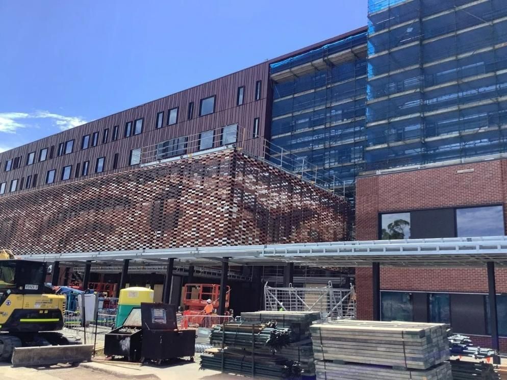 A Large Building Under Construction with A Lot of Machinery in Front of It — Site Safety NSW in Sandgate, NSW