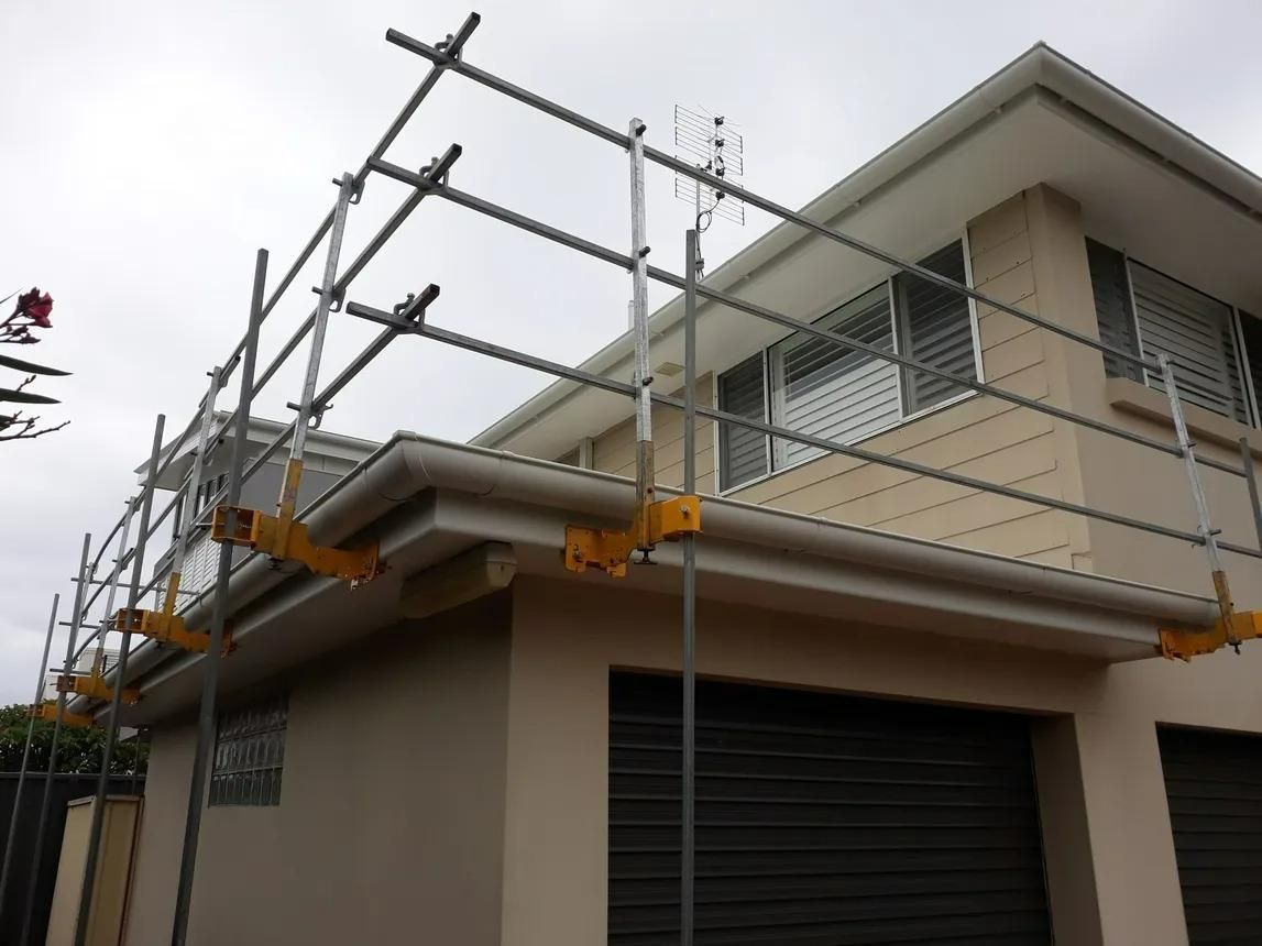 A House with Scaffolding on The Side of It — Site Safety NSW in Sandgate, NSW