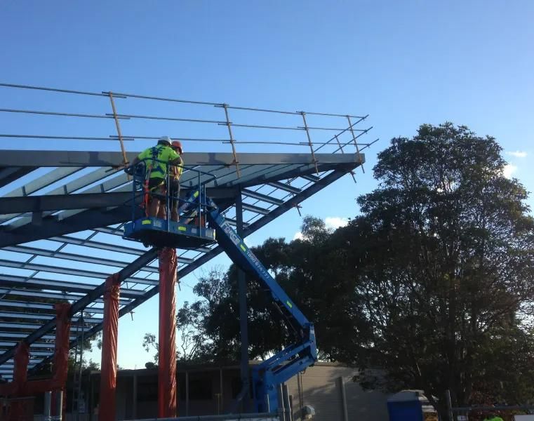 Two Construction Workers Are Working on A Metal Structure — Site Safety NSW in Sandgate, NSW