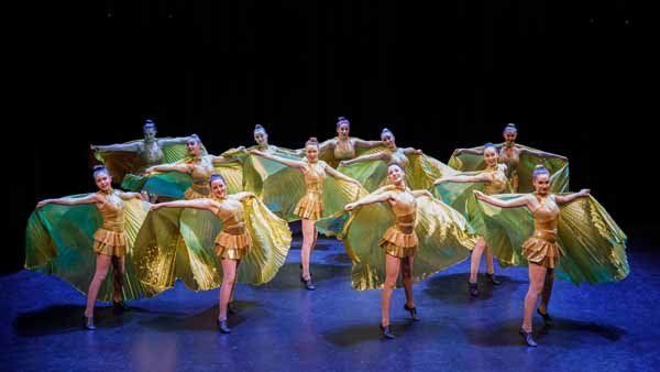 dancers in gold dresses