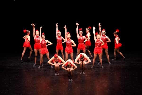 group of dancer posing in red