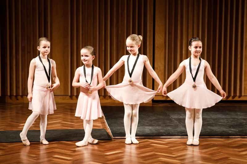 young girls in pink dresses