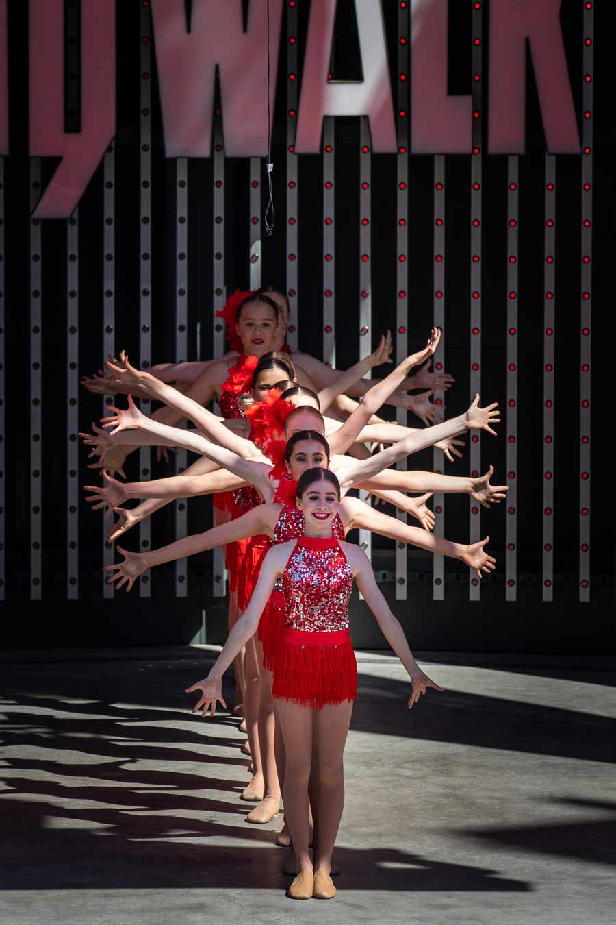 dance group on stage in red