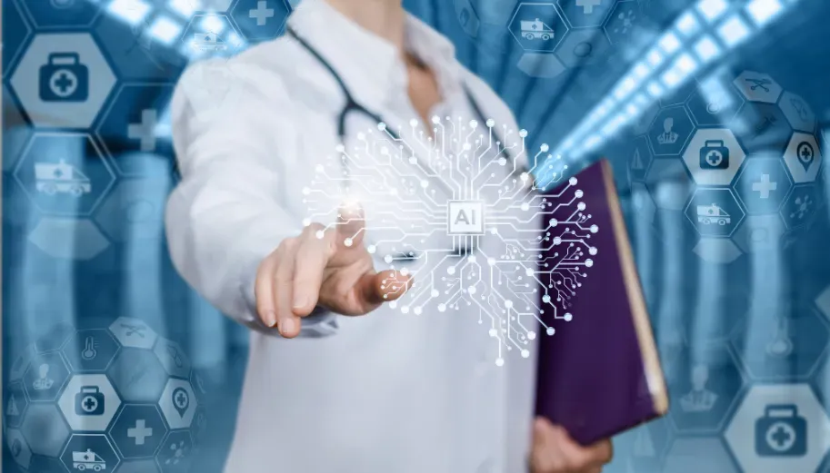 A doctor is holding a book and pointing at a computer screen.
