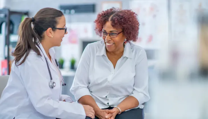 A doctor is talking to a patient in a hospital.