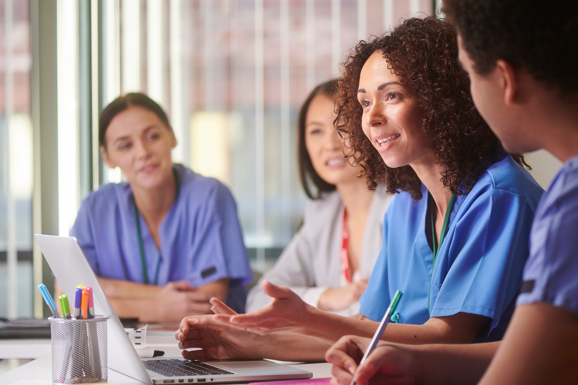 Healthcare professionals discussing workflow improvements using medical EHR systems during a team meeting