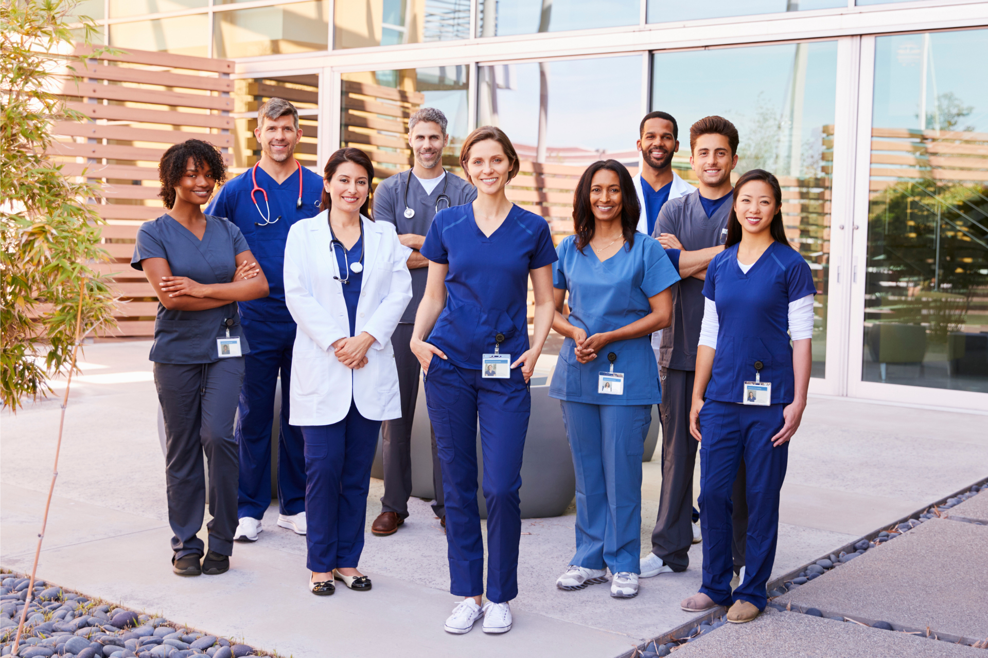 A healthcare team standing together and smiling for a group photo, showcasing the impact of effective clinical staffing solutions.