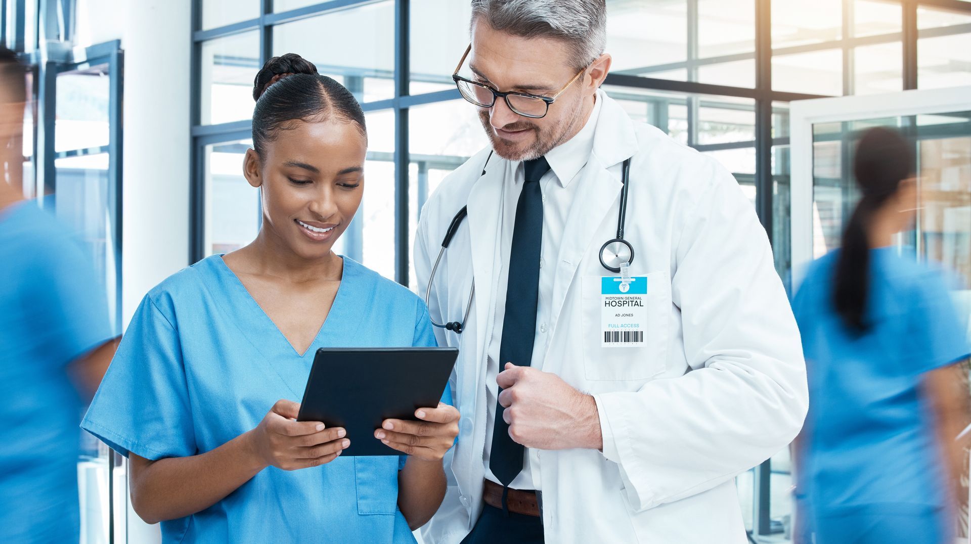 A healthcare team uses a patient engagement software on a tablet to enhance communication and treatment planning. 