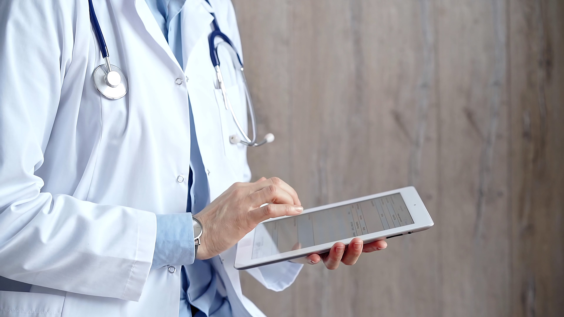 A nurse wearing a headset is sitting in front of a computer.