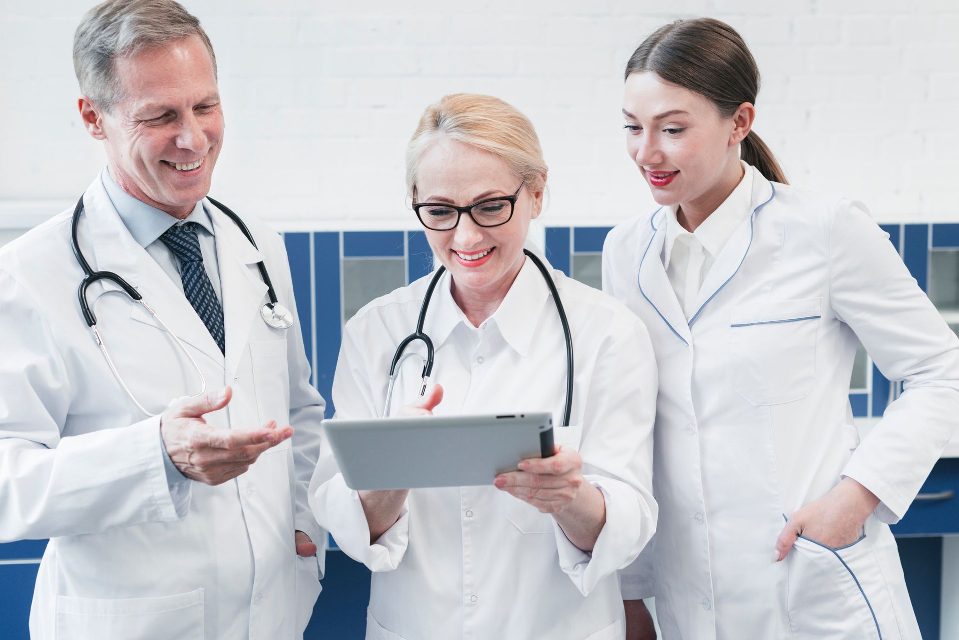Healthcare professionals look satisfied after a medical practice management software streamlined their workflow. 