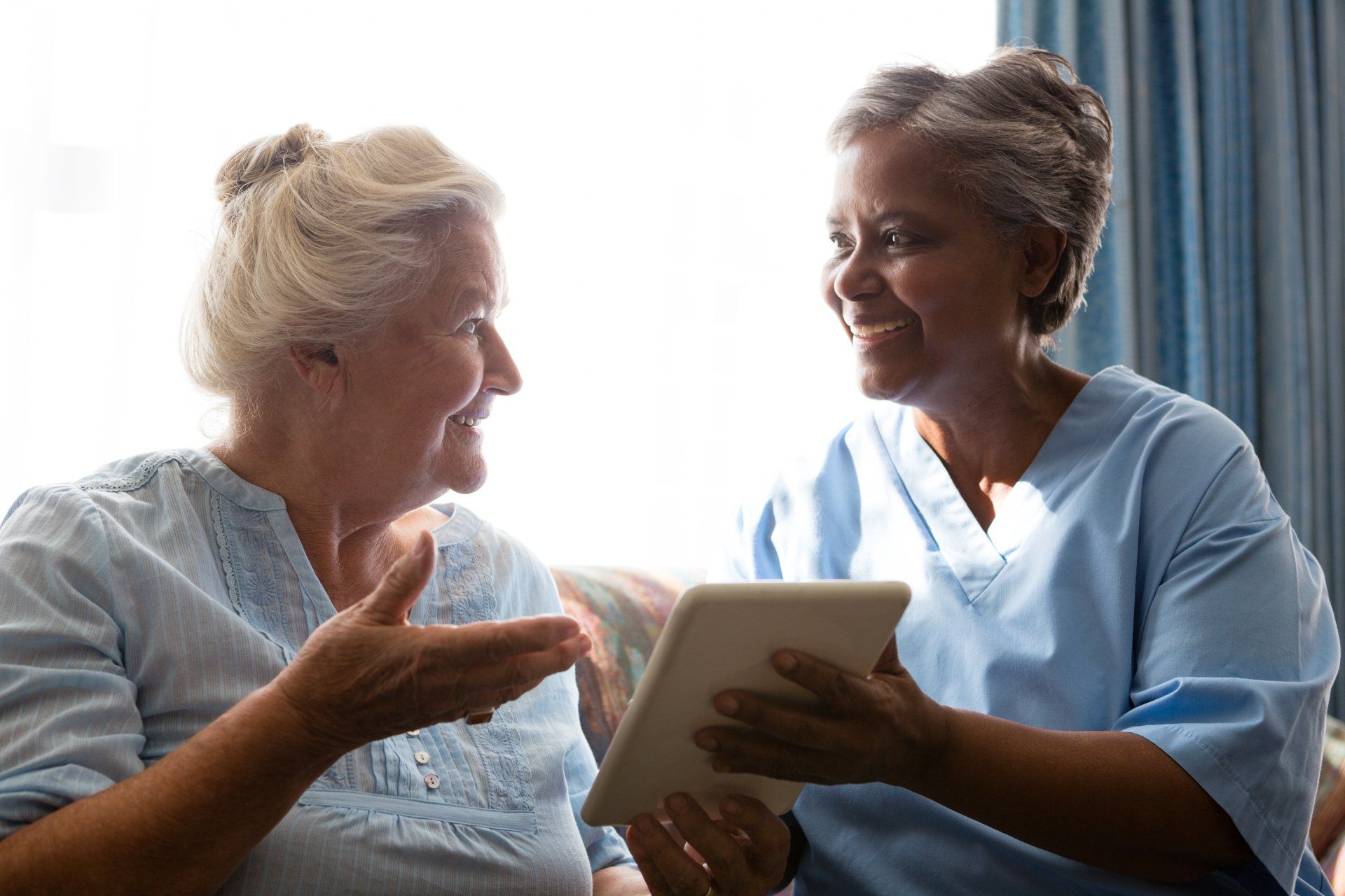 Senior woman and doctor laughing while using digit