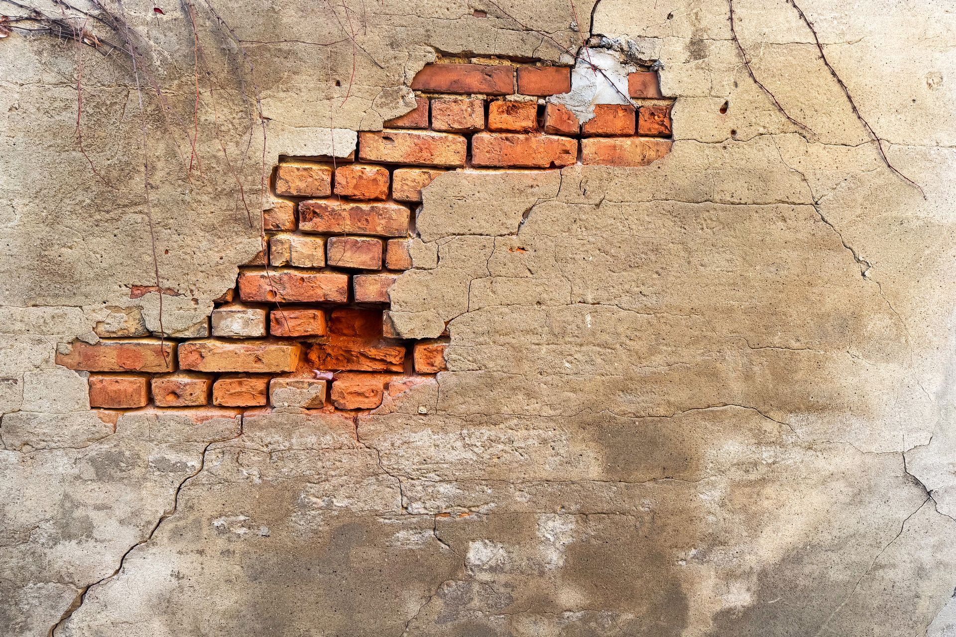 Person drilling concrete with a pneumatic hammer, spraying dust.