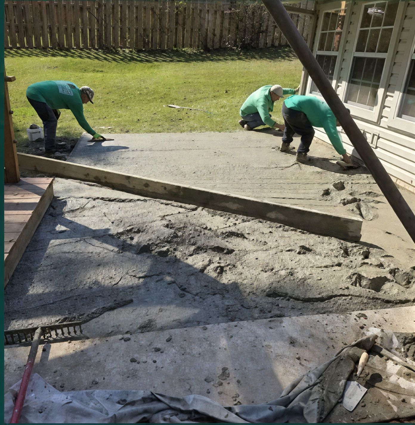Workers are repairing the pier & beam foundation with tools beside the house.