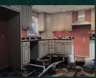 Kitchen floor lifted for pier & beam foundation repair showing exposed joists and pipes area AR.