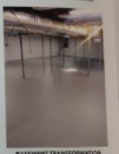 Empty, unfinished basement with gray floor and exposed support beams.