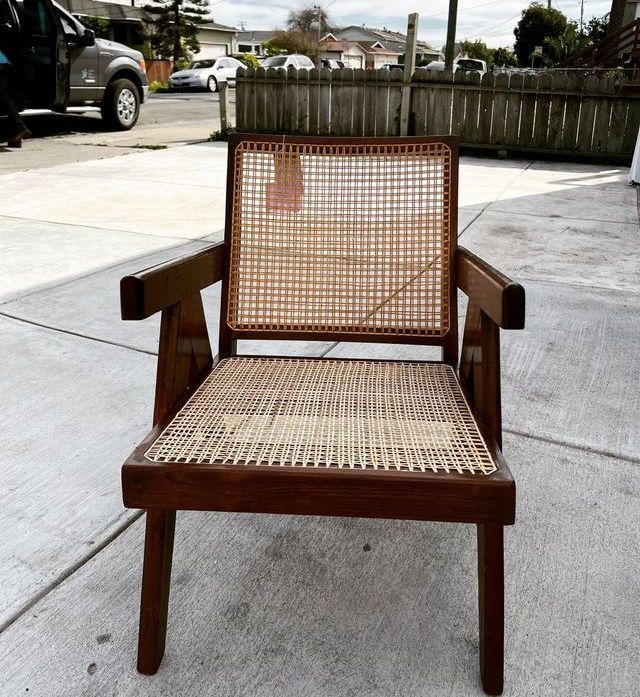 A wooden chair with a wicker seat and back