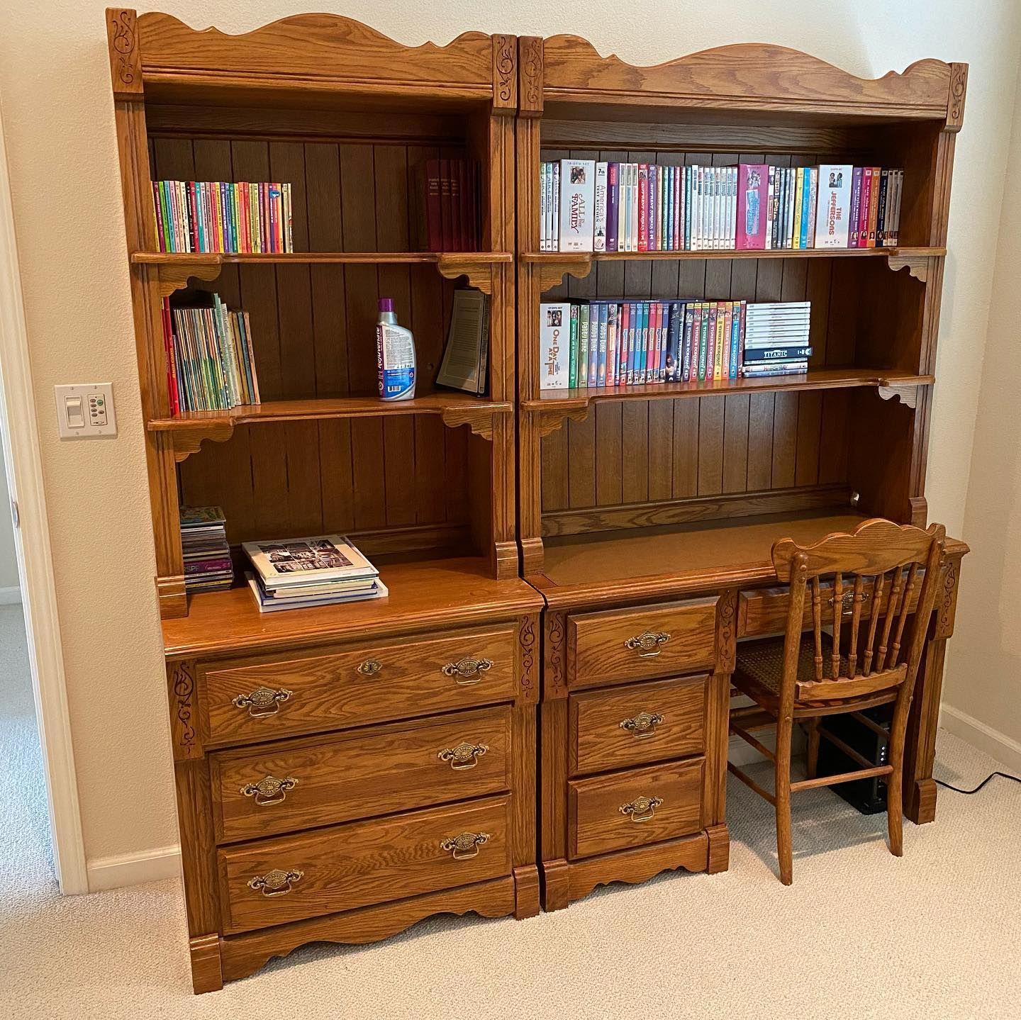 A wooden bookshelf with a desk and chair in a room