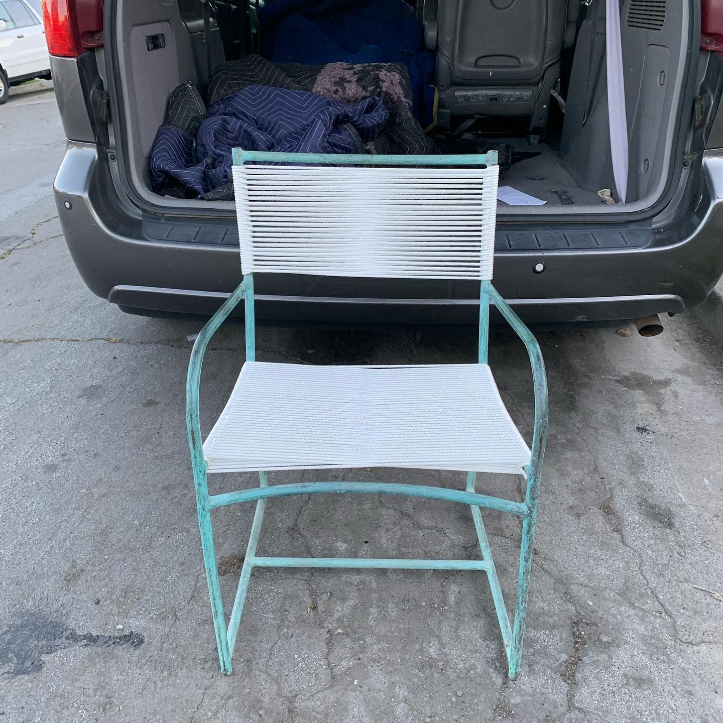 A chair is sitting in the back of a van.